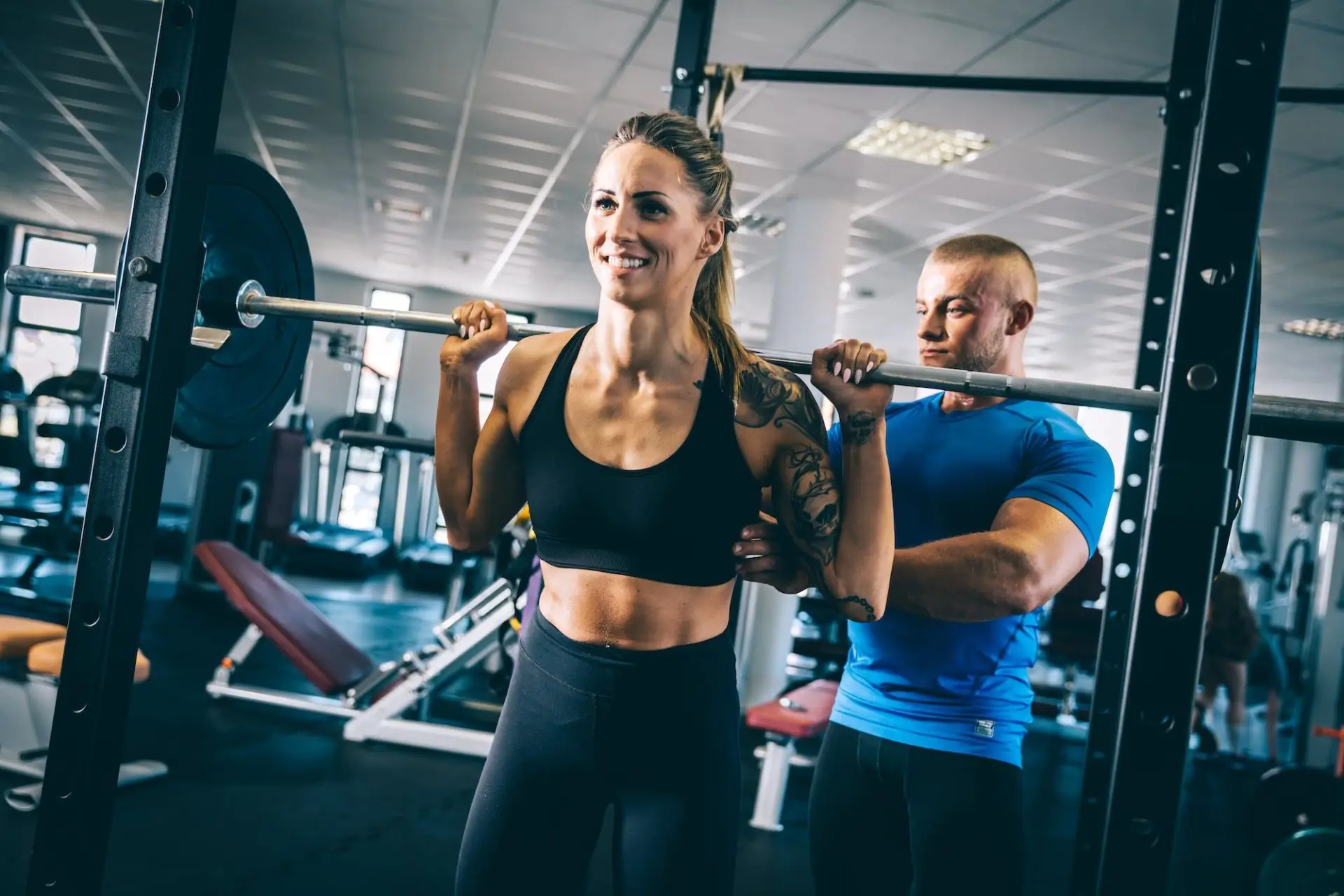 man-instructing-a-woman-on-a-gym-e1677564493307-21