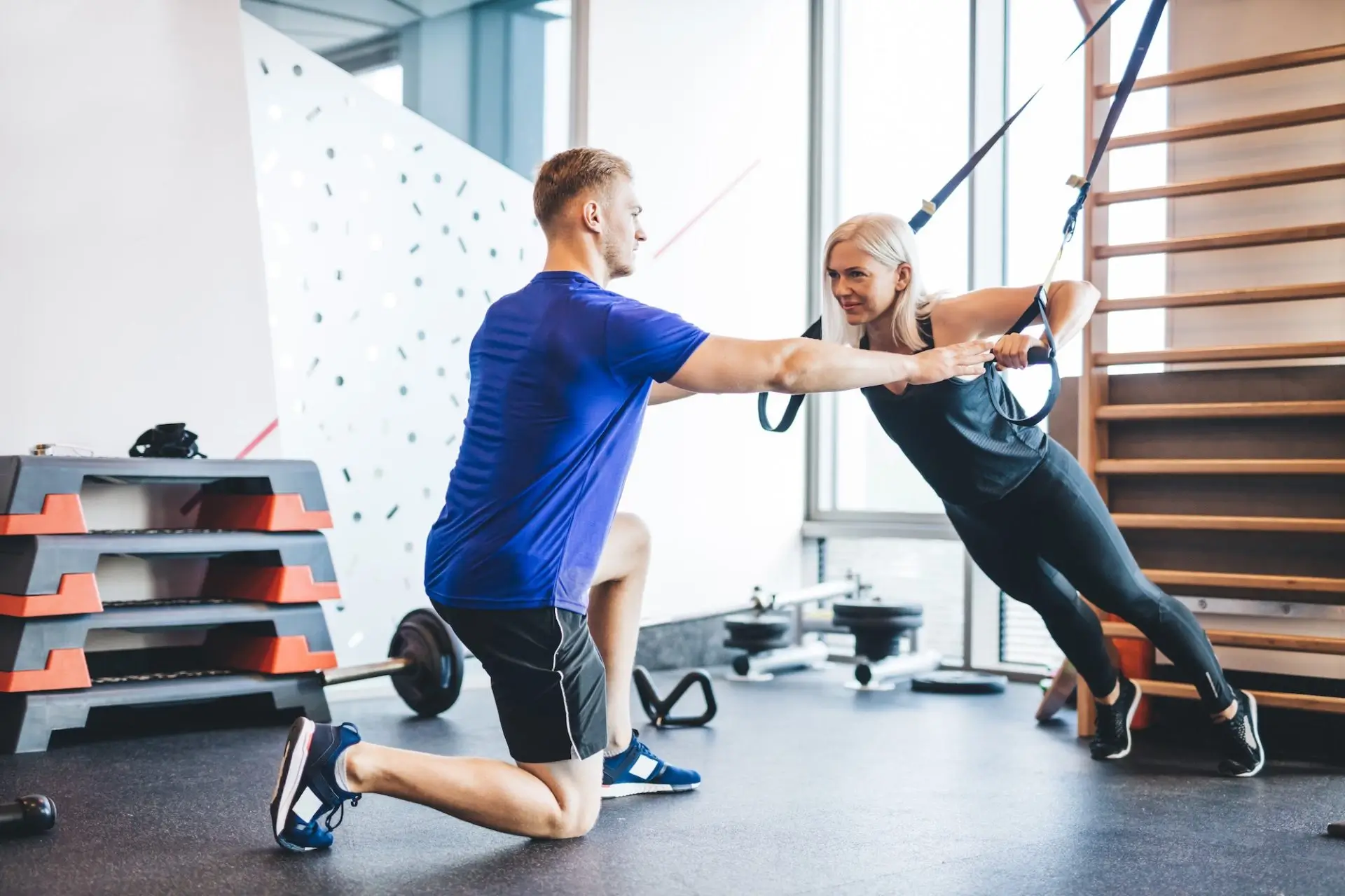 woman-exercising-with-personal-trainer-at-the-gym-e1677564552103-21