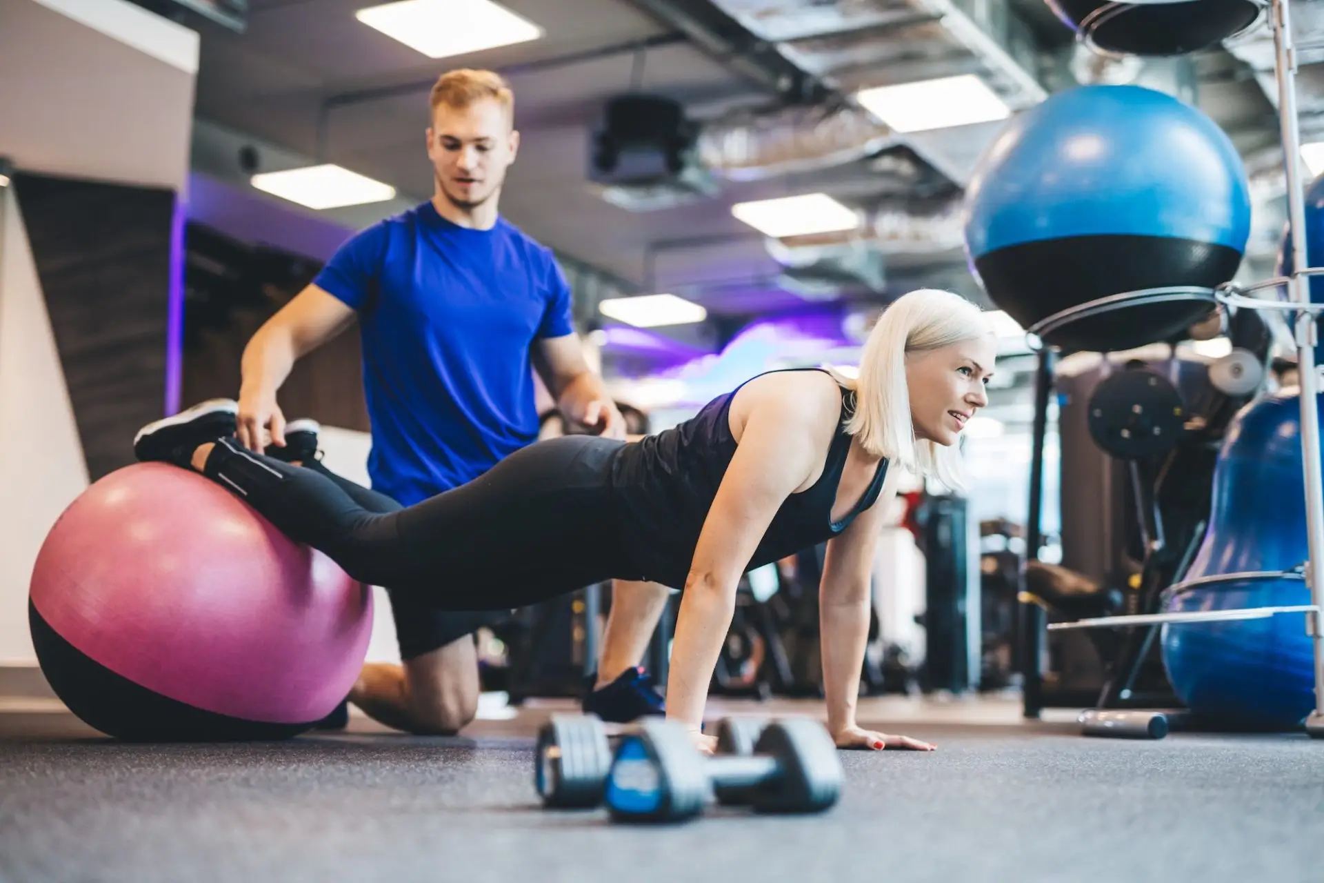 woman-working-out-on-a-ball-with-personal-trainer-e1677811662938-21